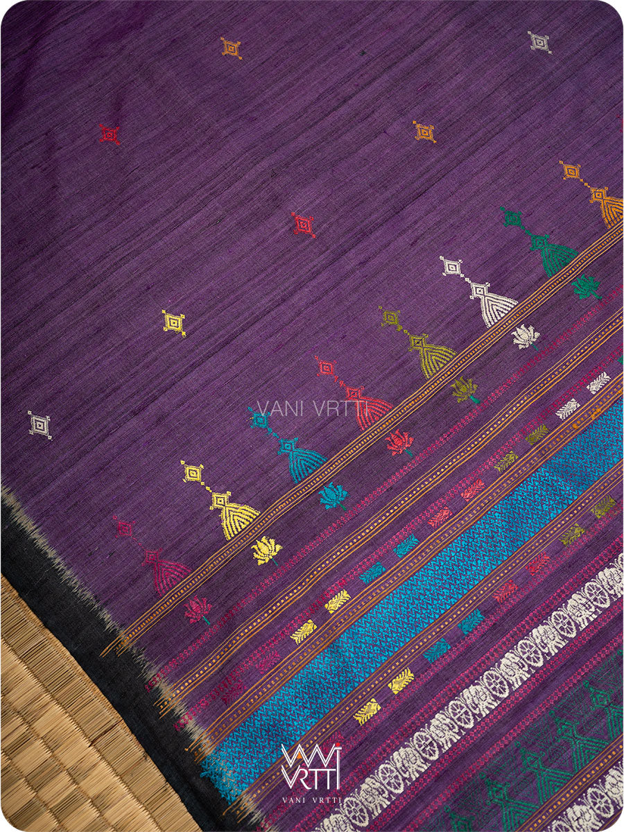Close up of handwoven motifs on deep baingani black tussar silk saree