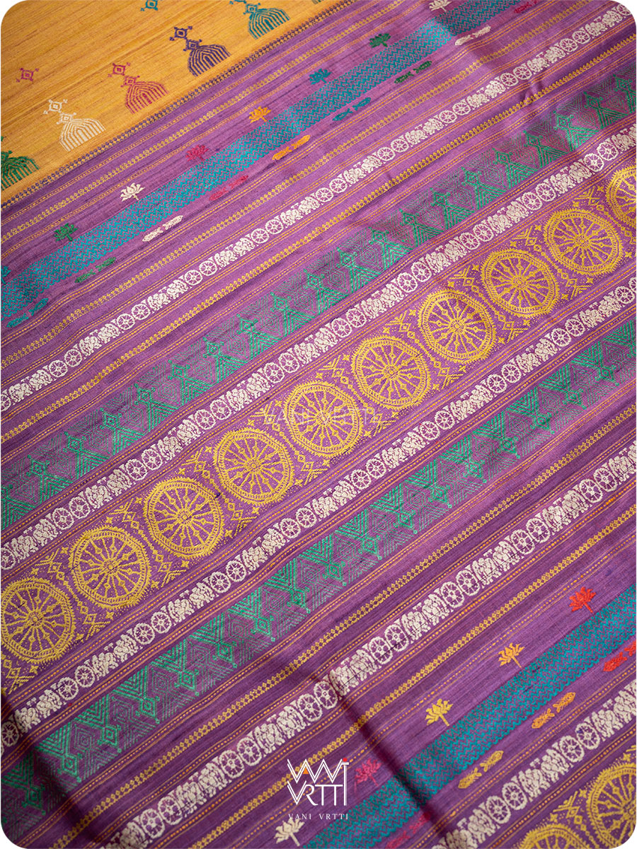 Close up of pallu with handwoven lotus flowers in pink, purple, and gold on tussar silk